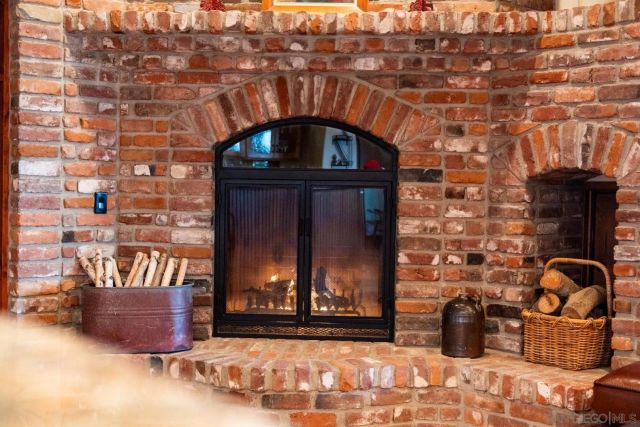 a living room with furniture a fireplace and wooden floor