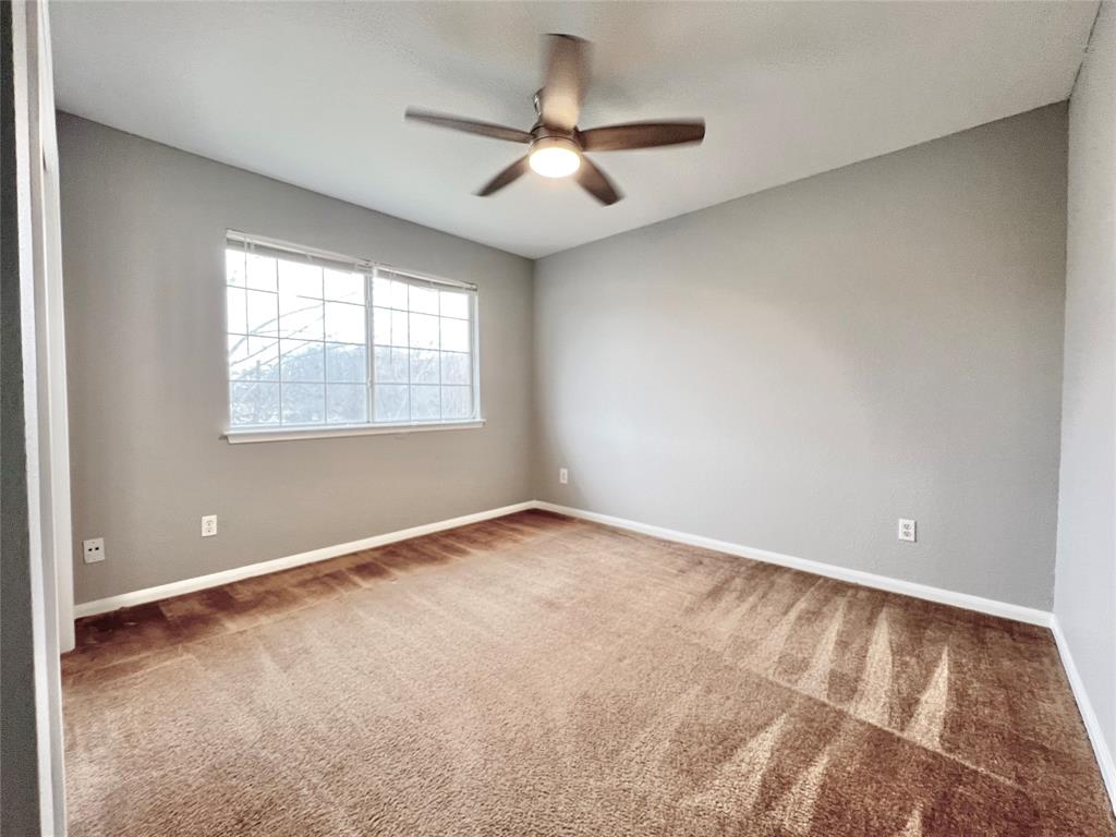 1809 Springwater Drive Round Rock, TX 78681 - Photo 14 of 25 Spare room featuring ceiling fan and light carpet