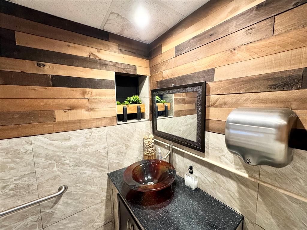 3080 Bee Ridge Road Sarasota, FL 34231 - Photo 13 of 25 a room with a couch and a flat screen tv