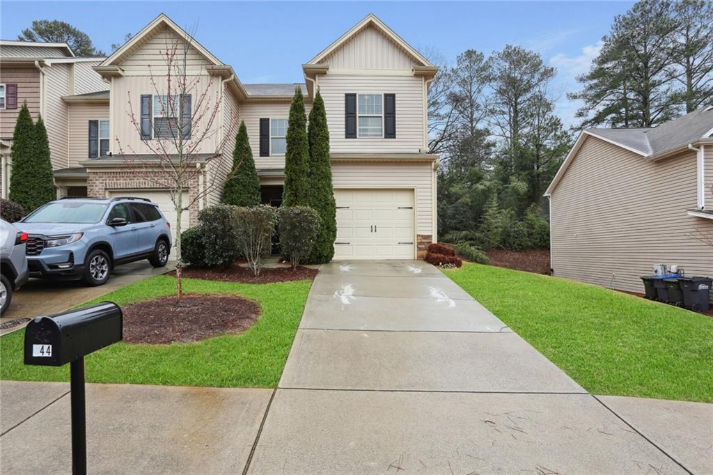 544 Oakside Place Acworth, GA 30102 - Photo 1 of 1 a front view of a house with a yard and garage