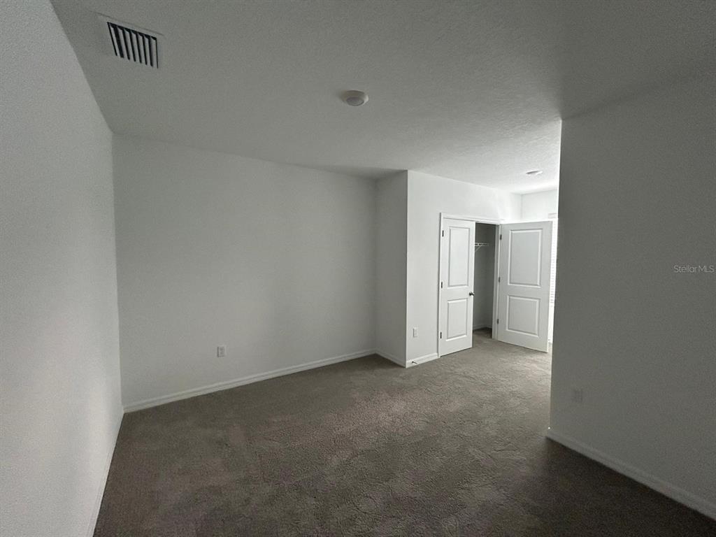16620 Grotto Steam Place Wimauma, FL 33598 - Photo 15 of 19 a view of an empty room and a window