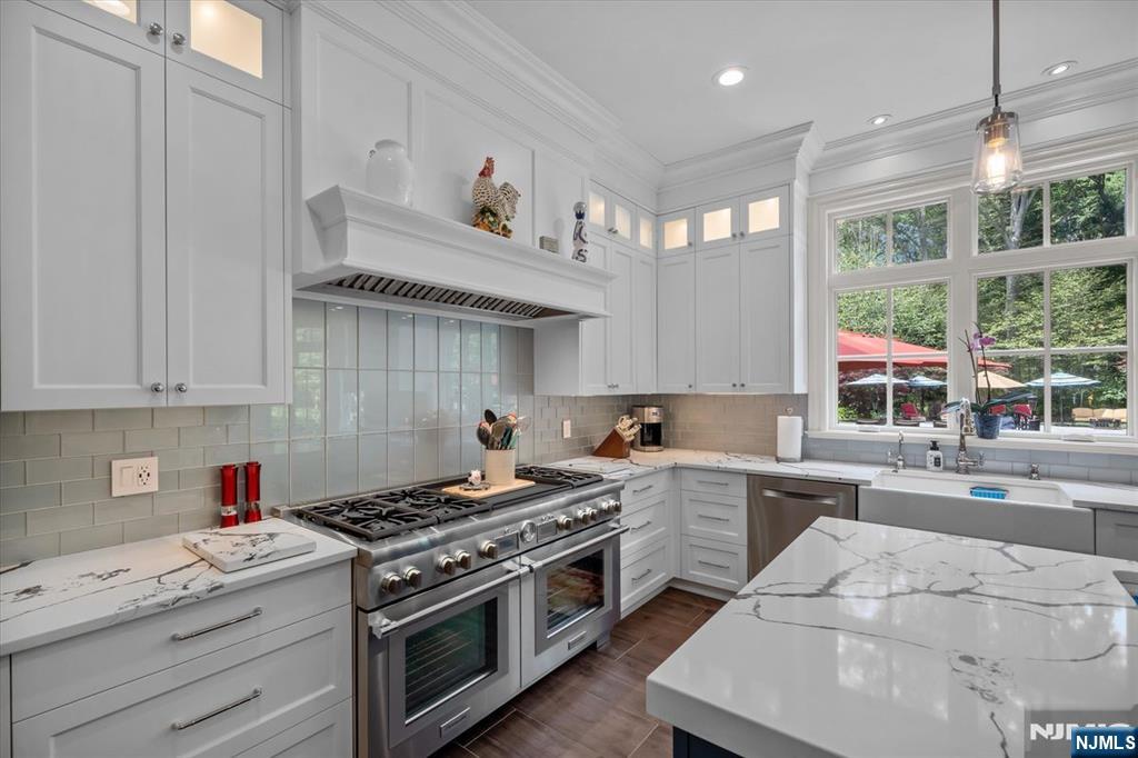 29 North Church Road Saddle River, NJ 07458 - Photo 12 of 42 a kitchen with a stove window and cabinets