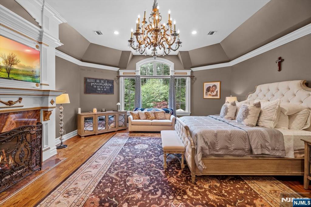 29 North Church Road Saddle River, NJ 07458 - Photo 21 of 42 a spacious bedroom with a bed and a chandelier