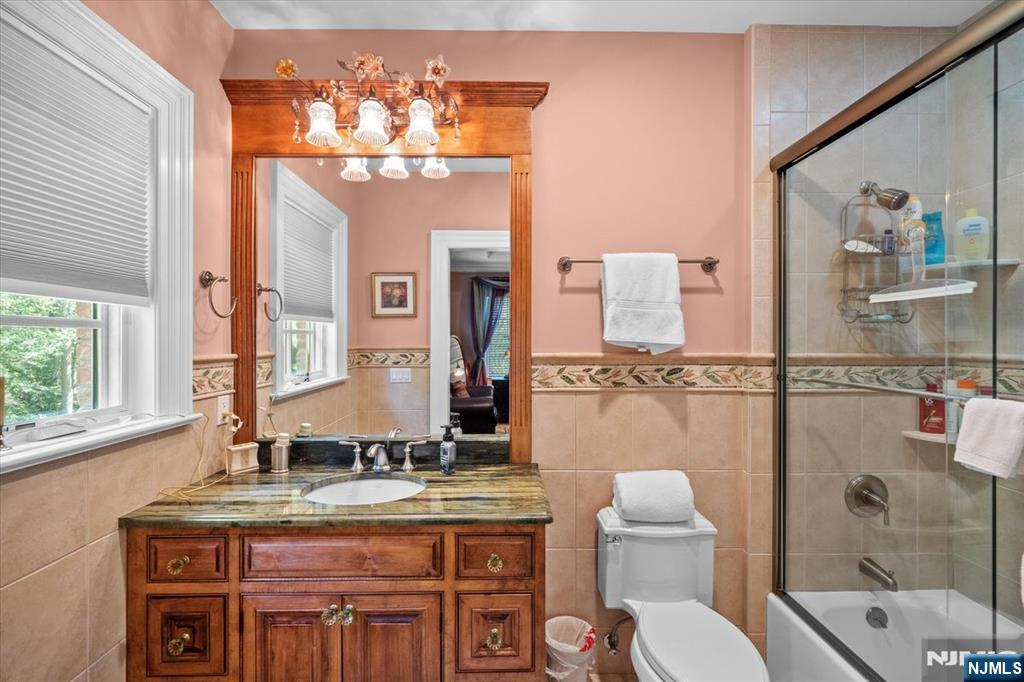 29 North Church Road Saddle River, NJ 07458 - Photo 25 of 42 a bathroom with a granite countertop sink a toilet and a mirror