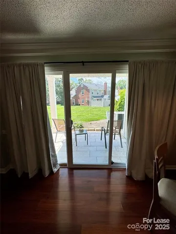a view of room with window and wooden floor