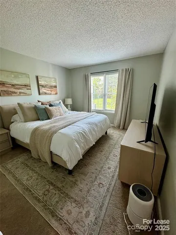 a bedroom with a bed and a chair