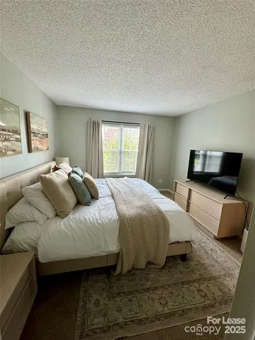 a bedroom with a bed and couch