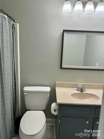 a bathroom with a sink mirror and toilet