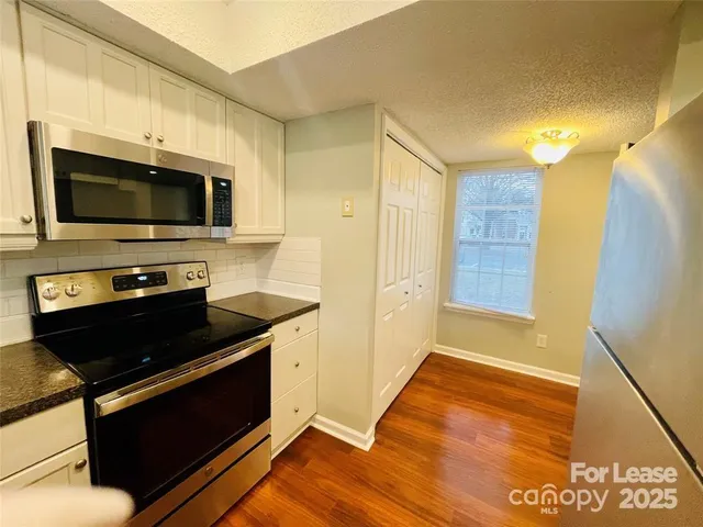 a kitchen with a stove and a microwave