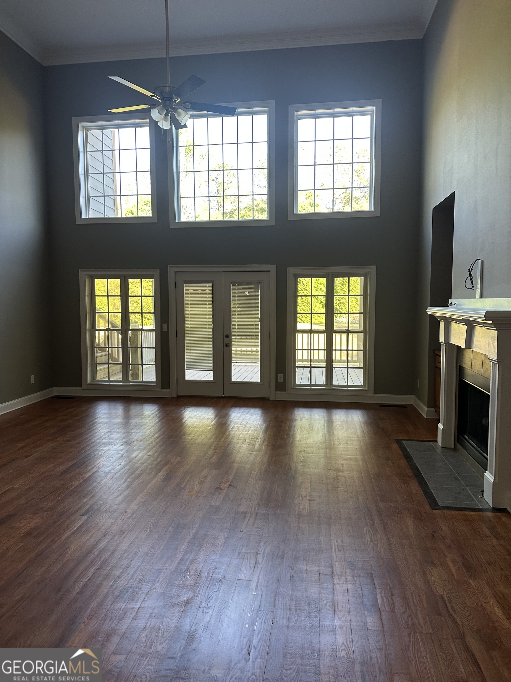 65 Spratlin Way Hull, GA 30646 - Photo 14 of 35 an empty room with wooden floor and windows