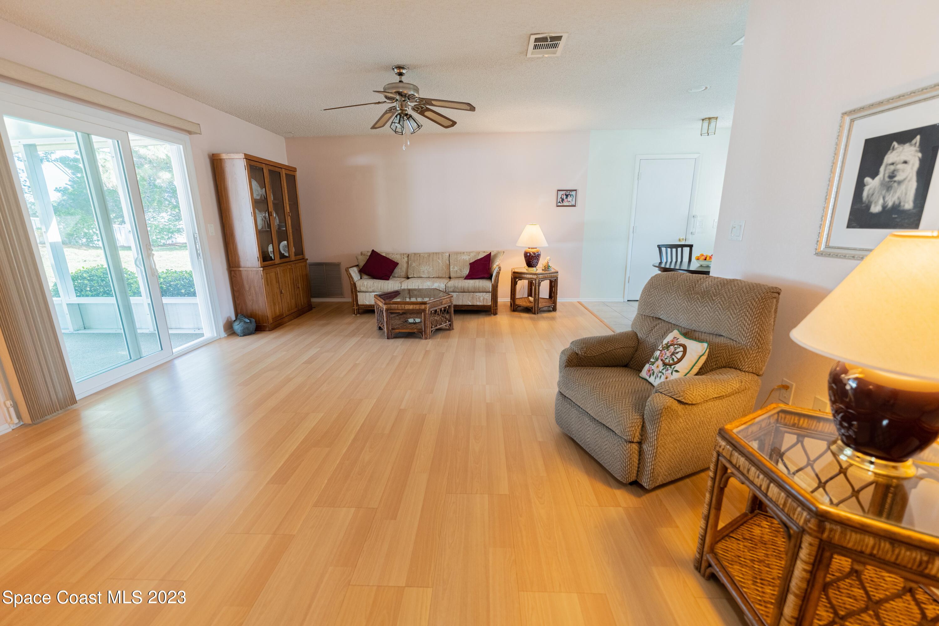920 Gables Way Melbourne, FL 32940 - Photo 13 of 24 a living room with furniture and a wooden floor