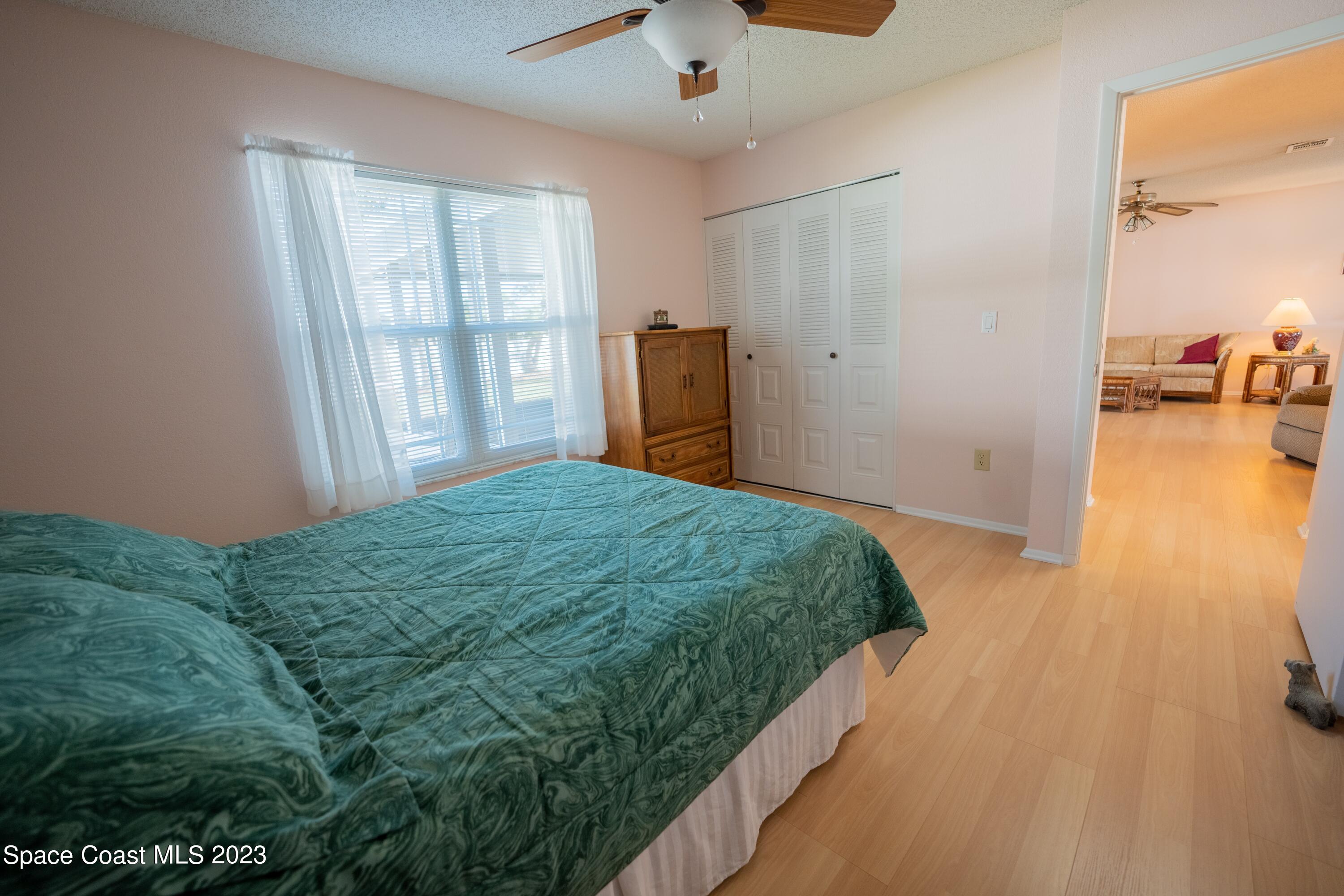 920 Gables Way Melbourne, FL 32940 - Photo 16 of 24 a bed sitting in a bedroom next to a window