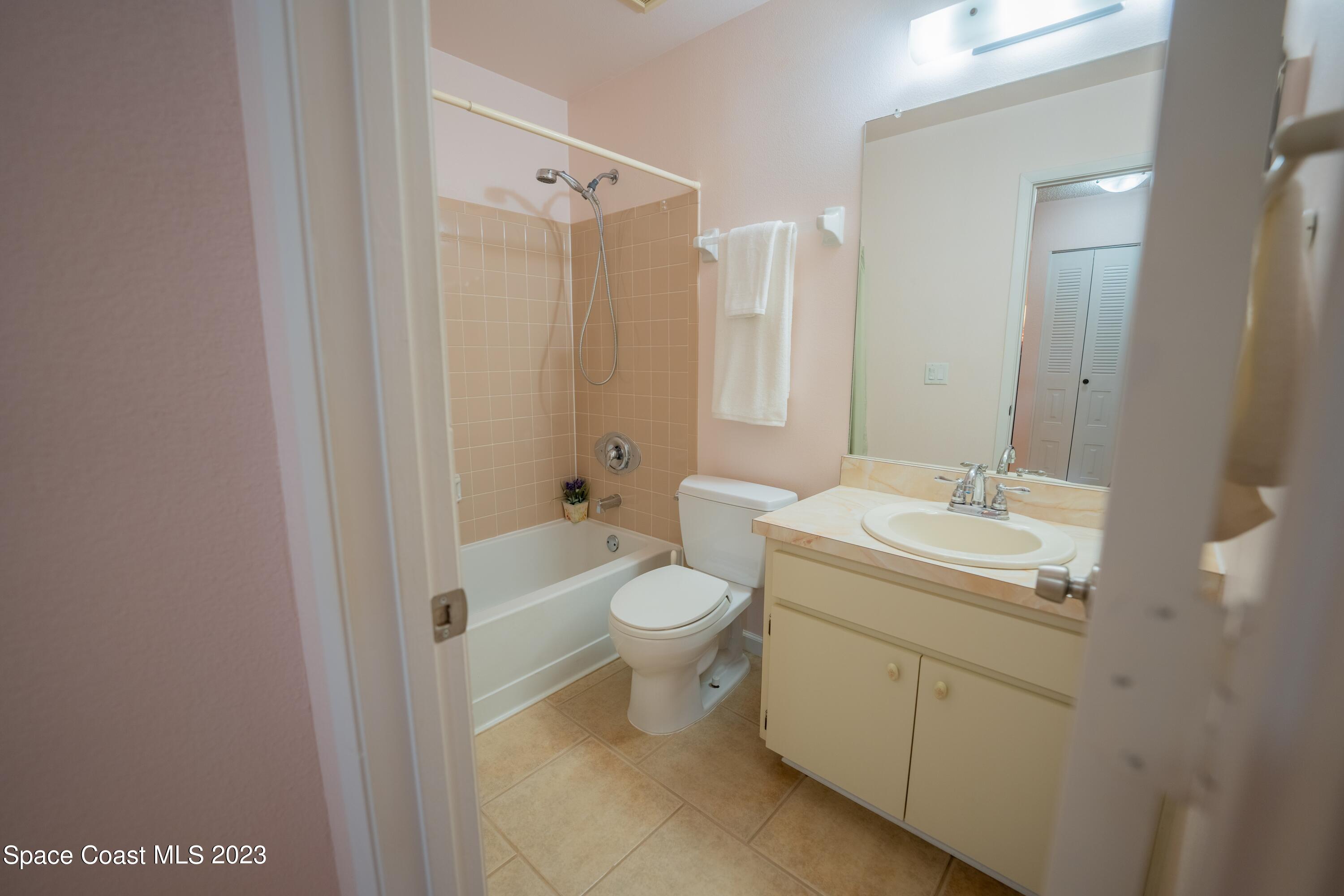 920 Gables Way Melbourne, FL 32940 - Photo 17 of 24 a bathroom with a granite countertop sink toilet and shower