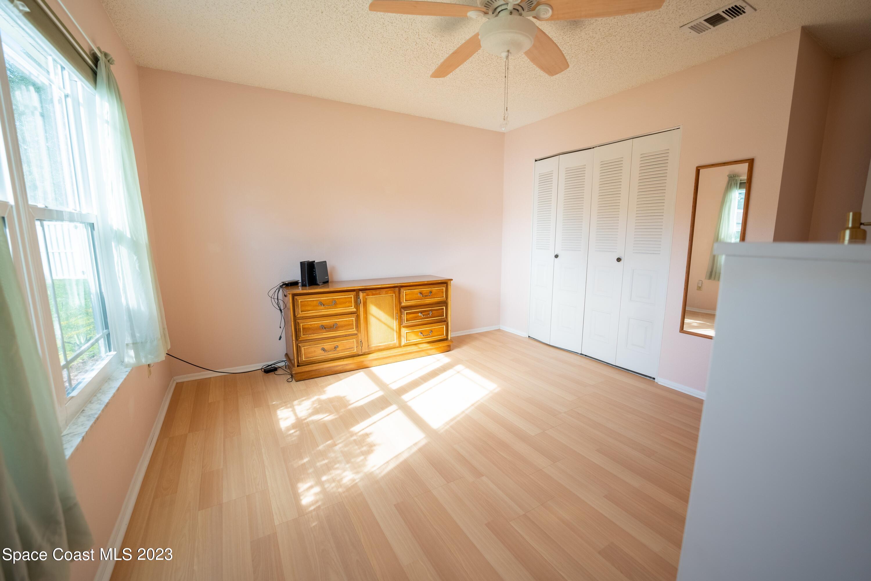 920 Gables Way Melbourne, FL 32940 - Photo 19 of 24 a view of a room with wooden floor and windows