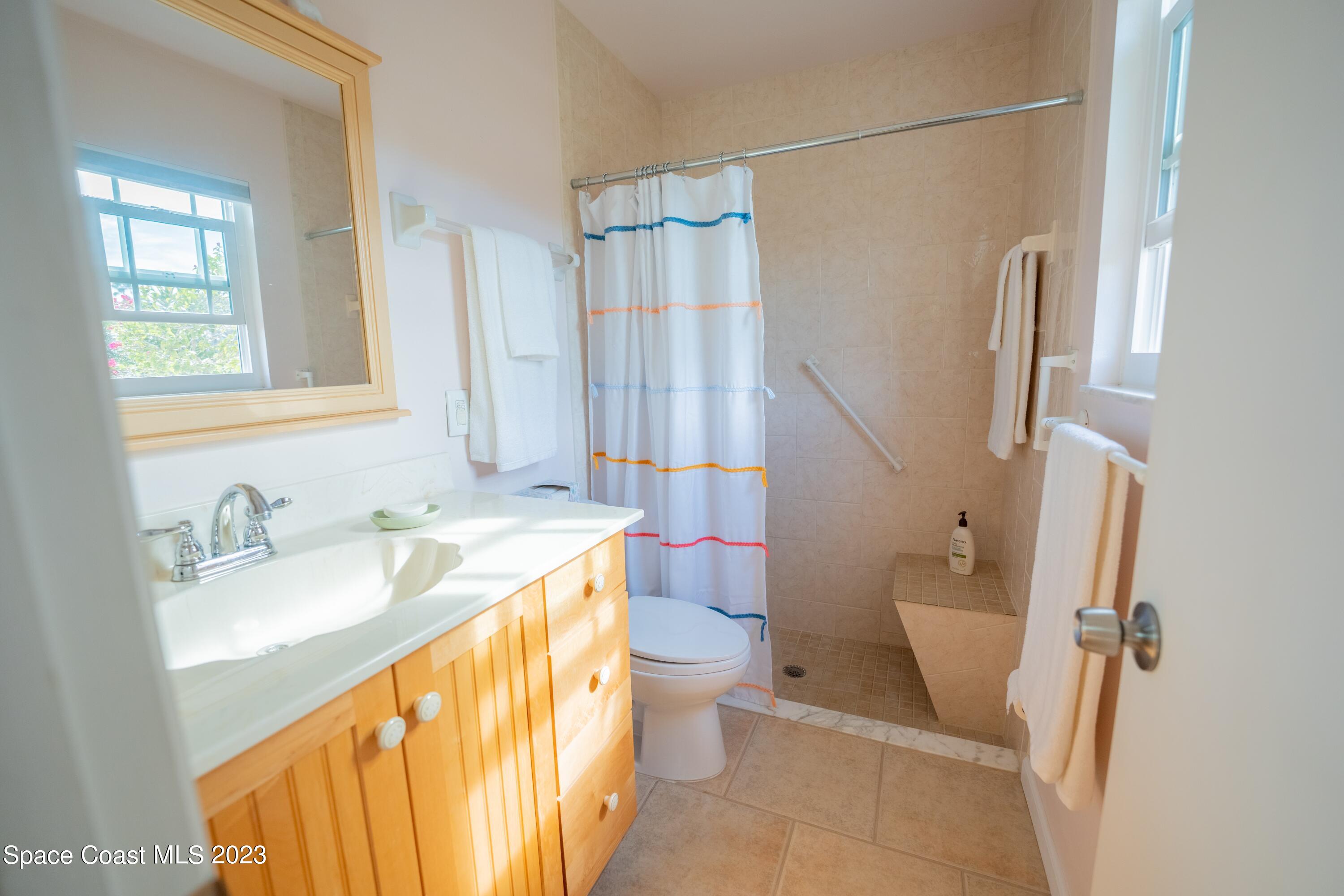 920 Gables Way Melbourne, FL 32940 - Photo 20 of 24 a bathroom with a sink a toilet and shower curtain
