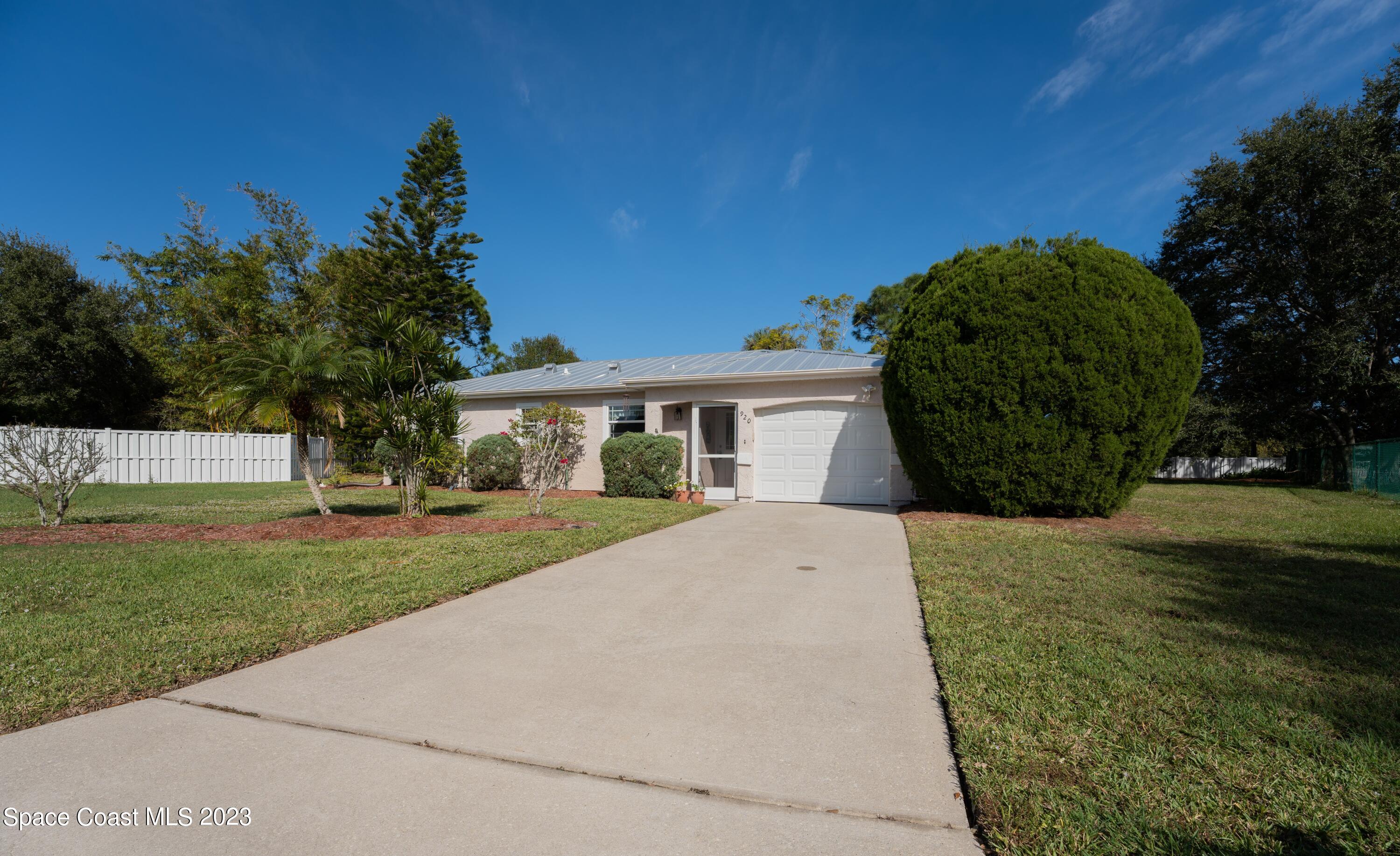 920 Gables Way Melbourne, FL 32940 - Photo 2 of 24 a front view of a house with garden
