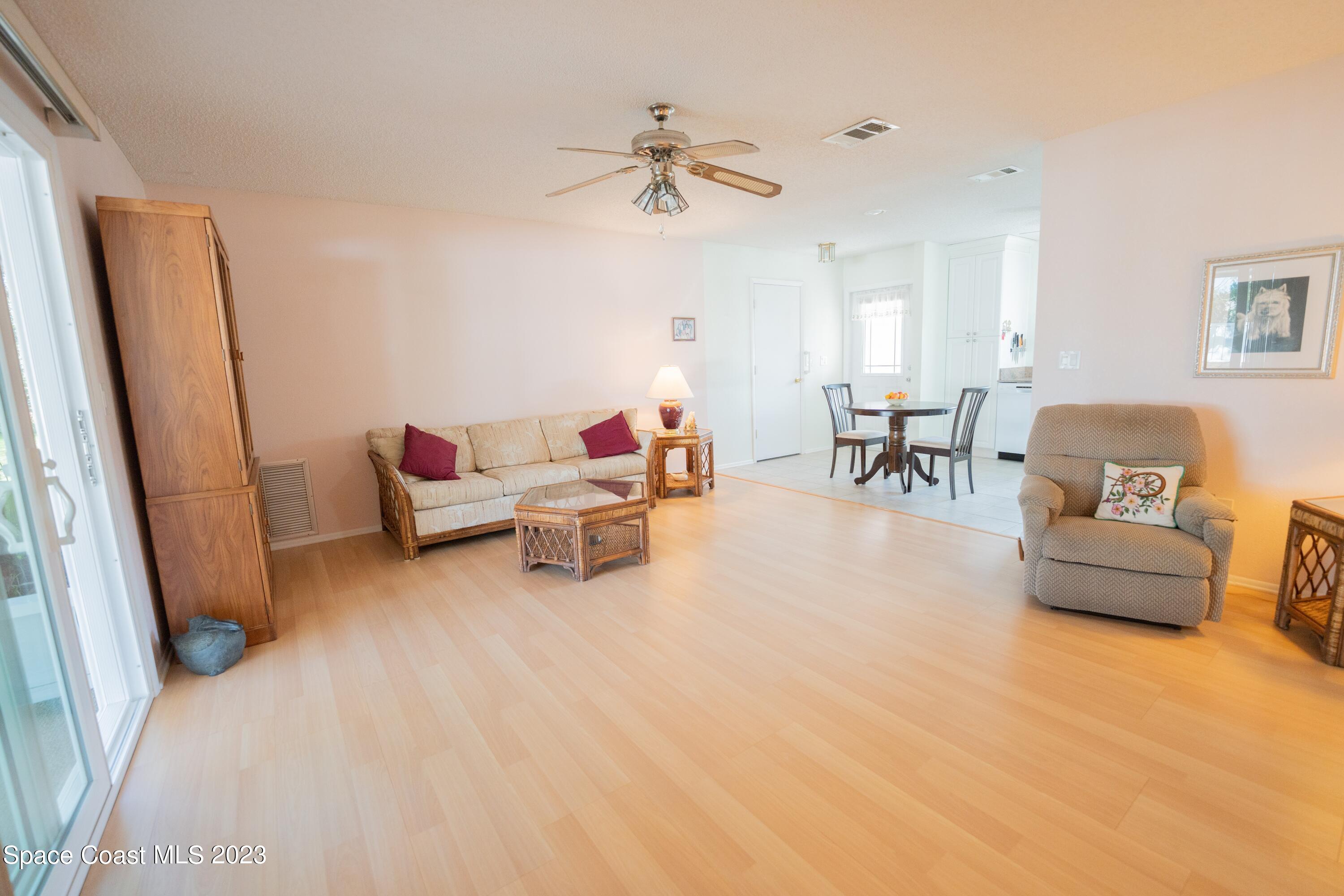 920 Gables Way Melbourne, FL 32940 - Photo 23 of 24 a living room with furniture and a chandelier