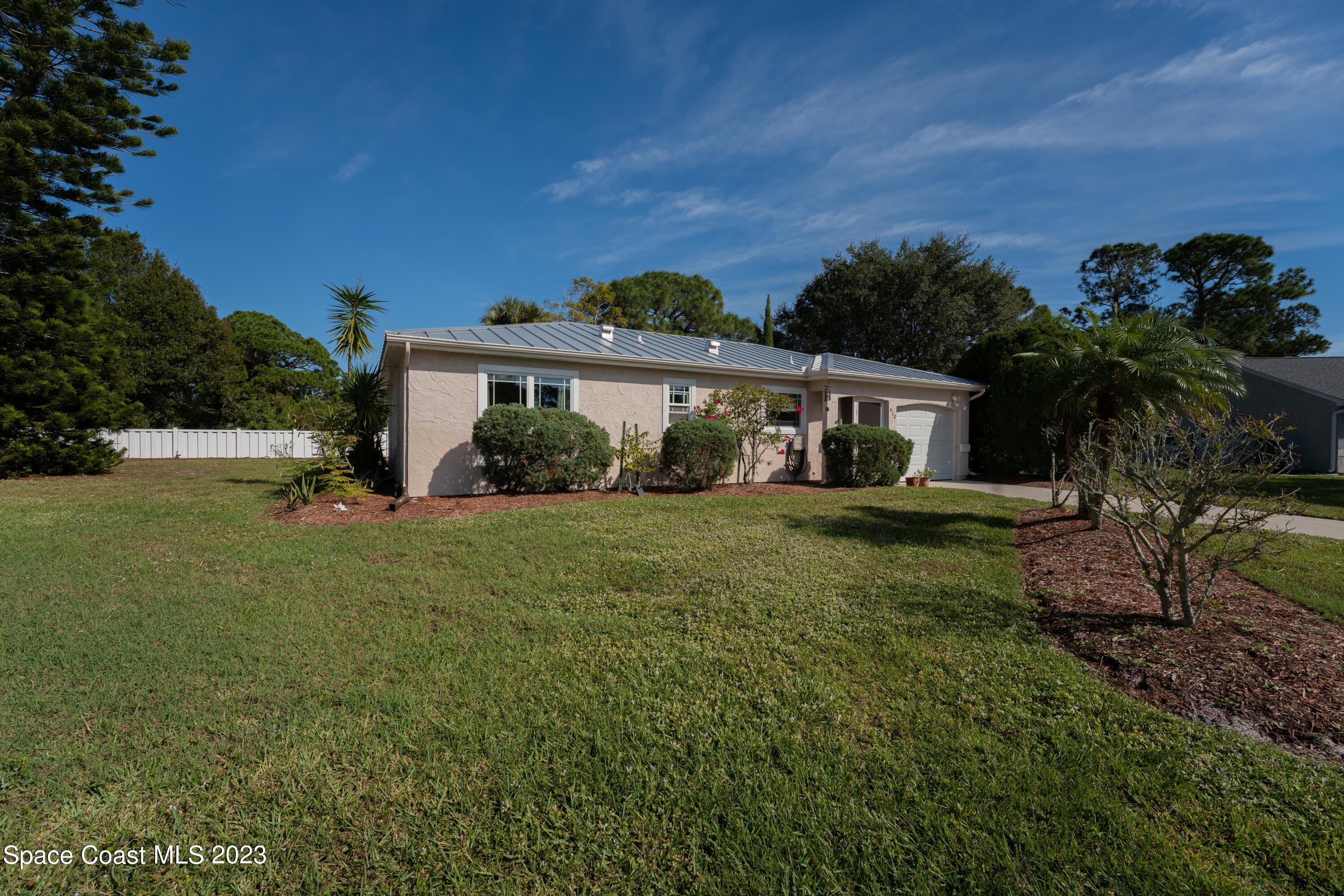 920 Gables Way Melbourne, FL 32940 - Photo 4 of 24 a front view of a house with garden