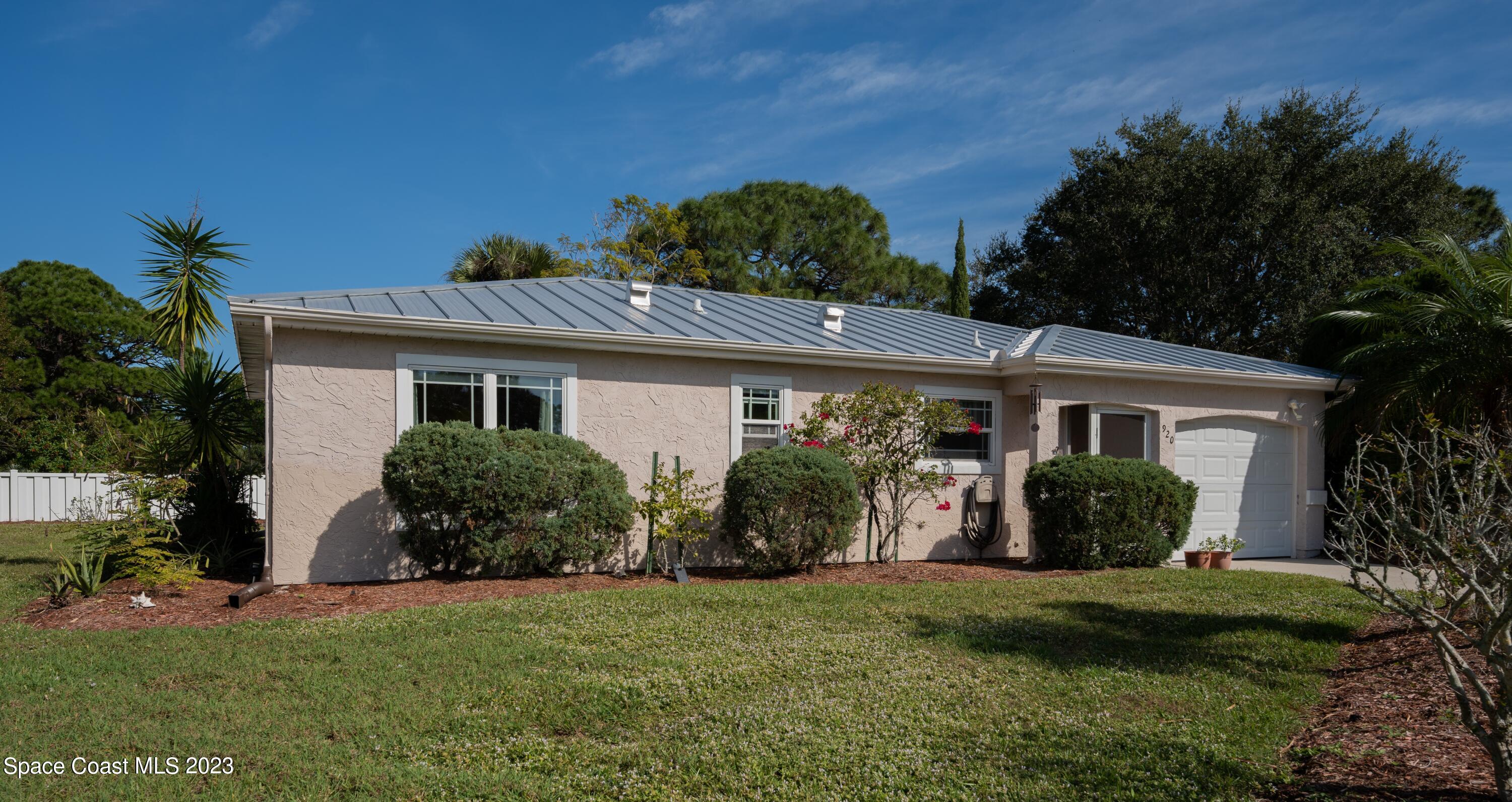 920 Gables Way Melbourne, FL 32940 - Photo 5 of 24 a front view of a house with a garden