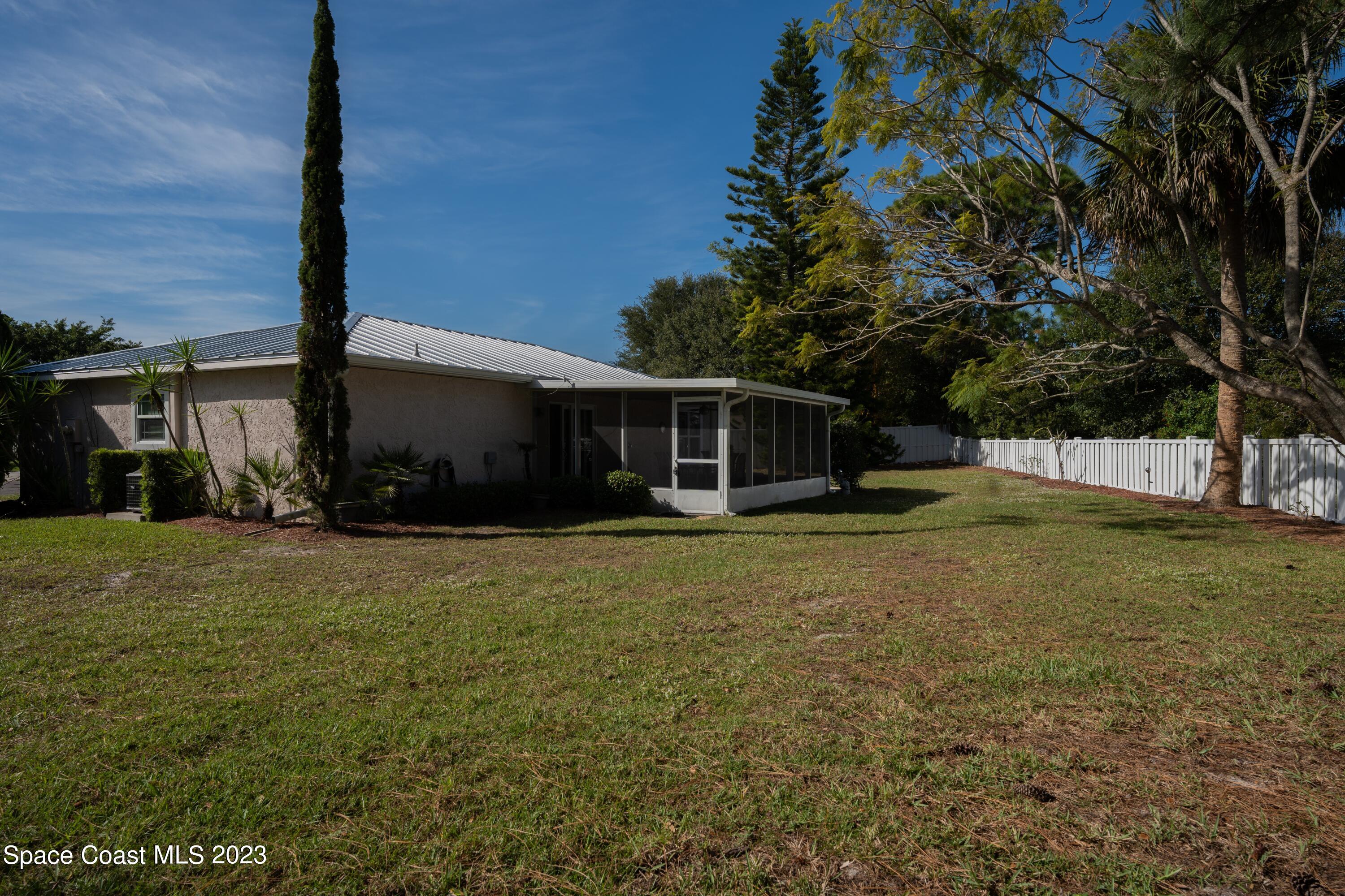 920 Gables Way Melbourne, FL 32940 - Photo 7 of 24 front view of a house with a yard
