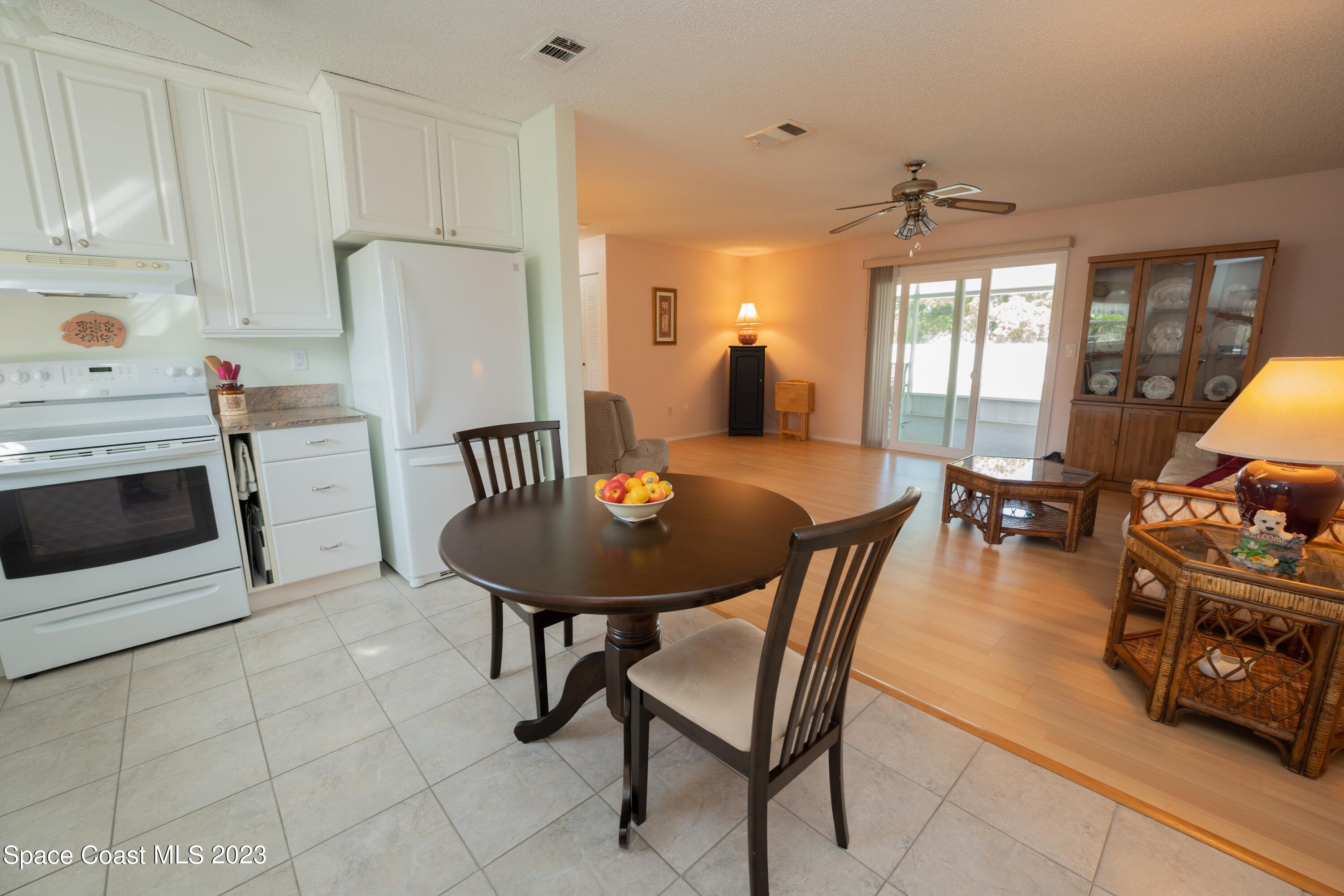 920 Gables Way Melbourne, FL 32940 - Photo 9 of 24 a view of a dining room with furniture and a chandelier