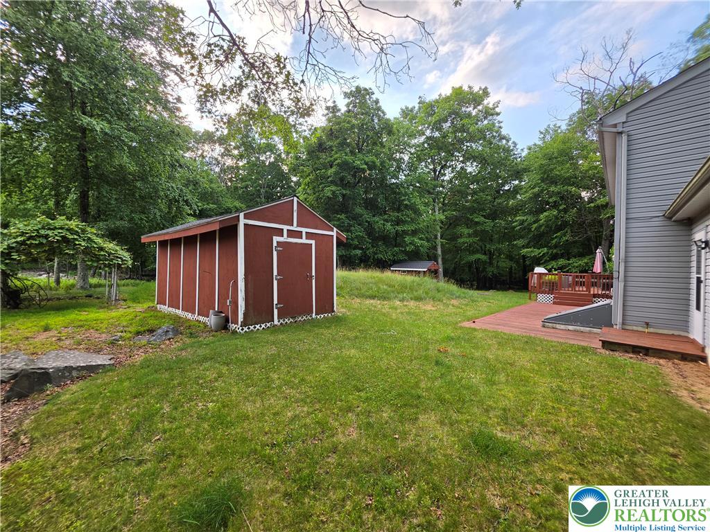 211 Murphy Circle Bushkill, PA 18324 - Photo 23 of 28 A quaint storage shed and a wooden deck complement the home's wooded setting.