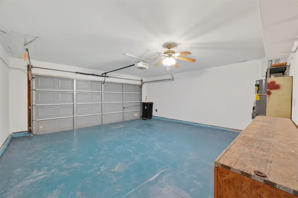 a view of a room with cabinet and a ceiling fan