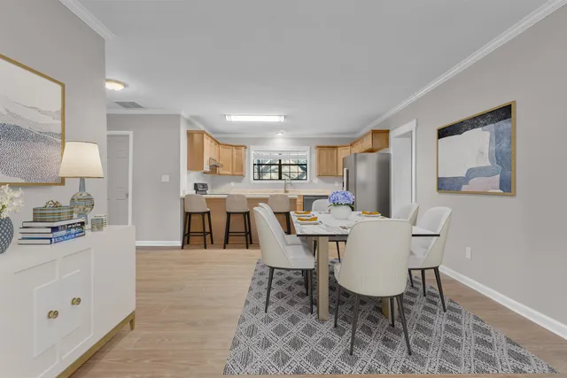 a view of a dining room with furniture and wooden floor