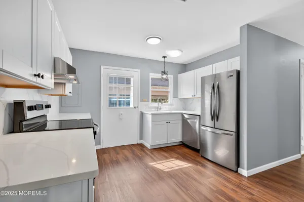 a kitchen with stainless steel appliances a refrigerator sink and microwave