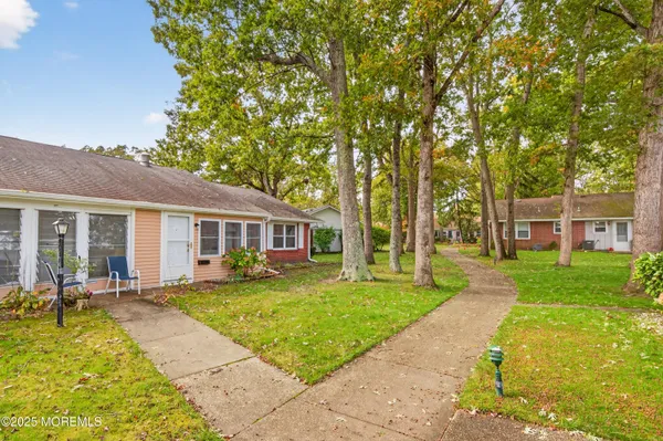a front view of a house with a yard table and chairs
