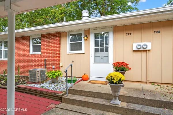 a white bench sitting in front of a house