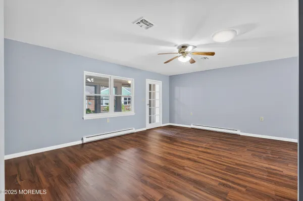 wooden floor in an empty room with a window