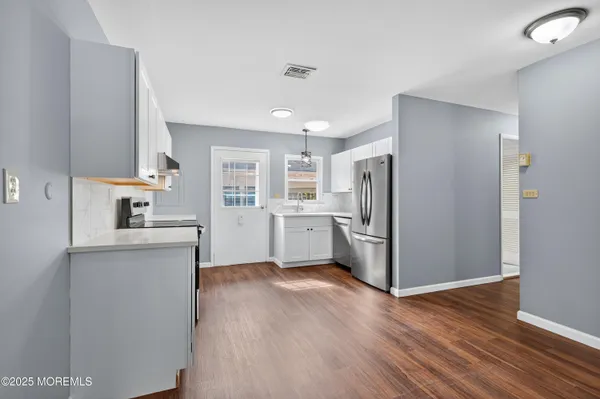 a kitchen with stainless steel appliances a refrigerator and a sink
