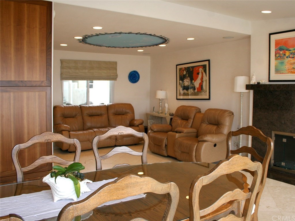 614 The Strand Manhattan Beach, CA 90266 - Photo 17 of 41 a media room with lots of chairs and a chandelier