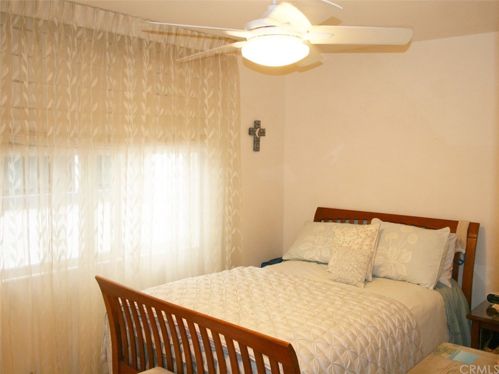 614 The Strand Manhattan Beach, CA 90266 - Photo 22 of 41 a bedroom with a bed and a chandelier