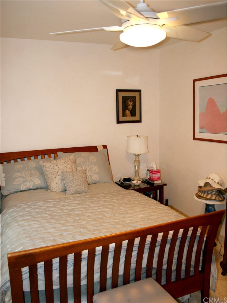 614 The Strand Manhattan Beach, CA 90266 - Photo 23 of 41 a bedroom with a bed and a chandelier