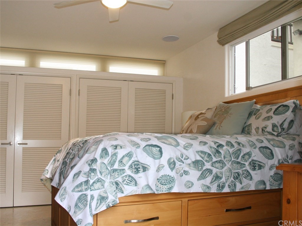 614 The Strand Manhattan Beach, CA 90266 - Photo 27 of 41 a bedroom with a bed and a window