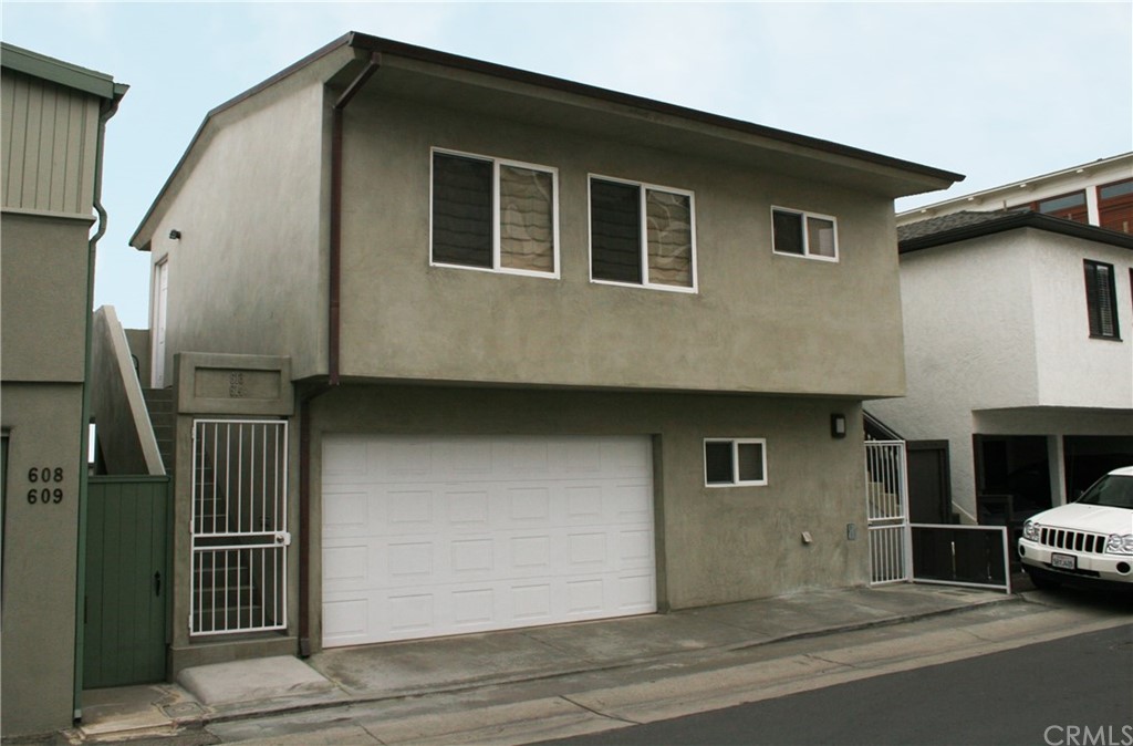 614 The Strand Manhattan Beach, CA 90266 - Photo 37 of 41 a front view of a house with garage