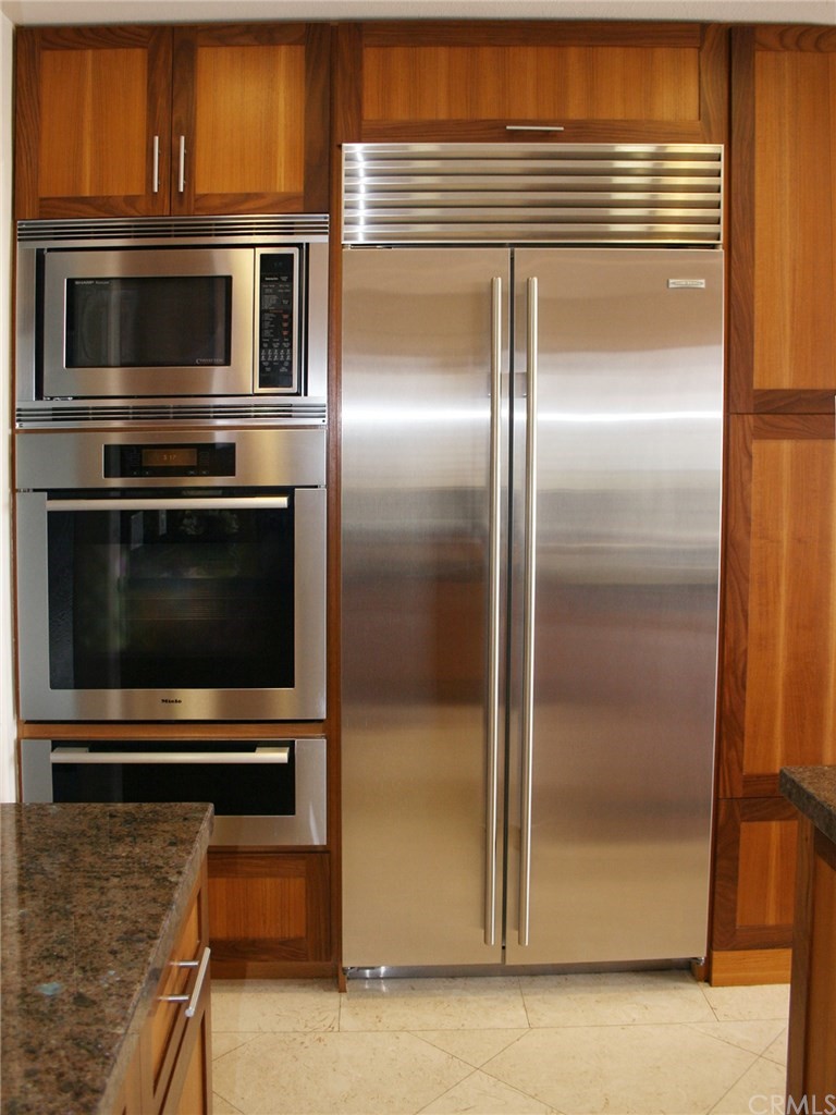 614 The Strand Manhattan Beach, CA 90266 - Photo 8 of 41 a kitchen with a refrigerator stove and cabinets