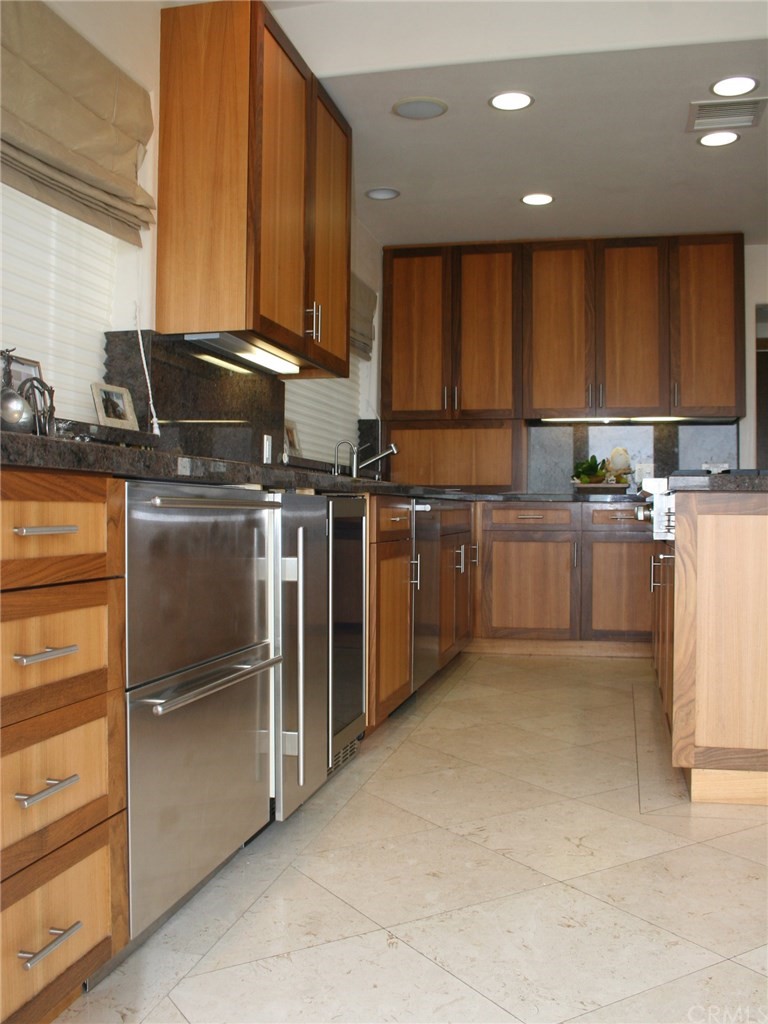 614 The Strand Manhattan Beach, CA 90266 - Photo 9 of 41 a kitchen with stainless steel appliances granite countertop a refrigerator stove and sink