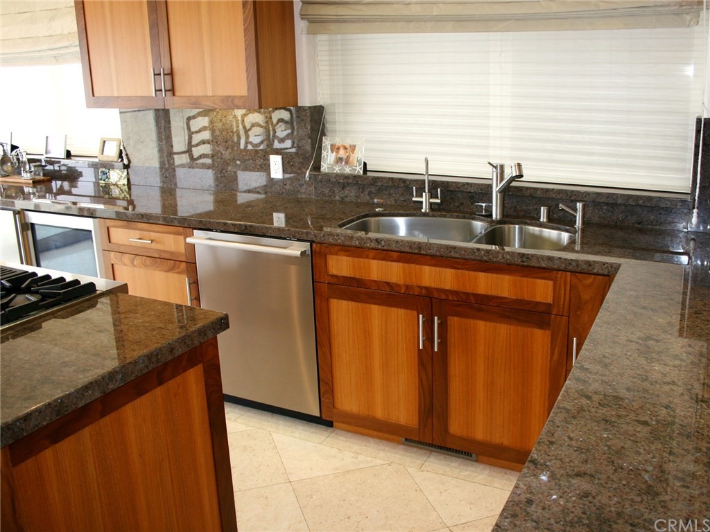 614 The Strand Manhattan Beach, CA 90266 - Photo 10 of 41 a kitchen with granite countertop sink cabinets and window