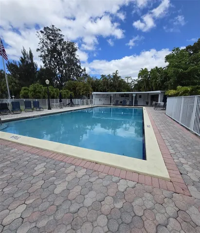 a view of a swimming pool with a yard