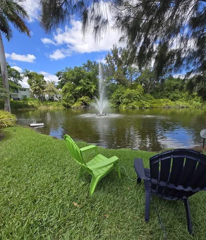 a view of a lake with a garden and a table