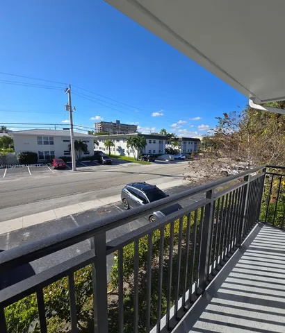 a view of a balcony and yard
