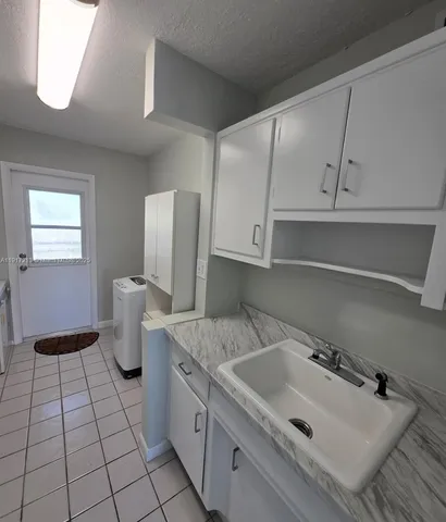 a kitchen with a sink and cabinets