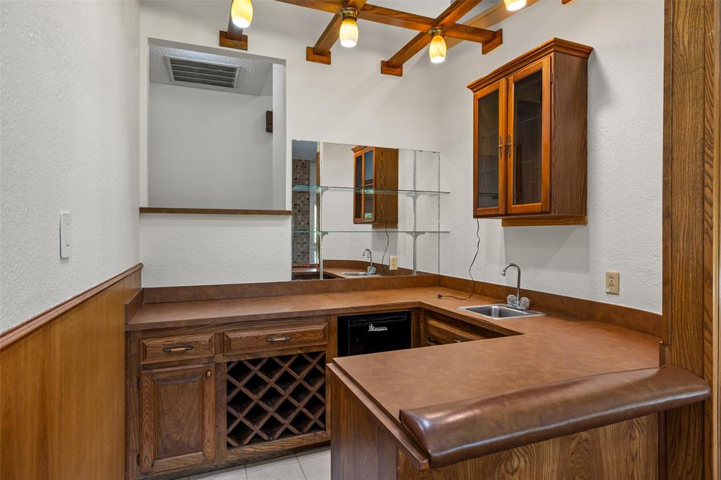 7508 Ravenswood Road Granbury, TX 76049 - Photo 13 of 40 a kitchen that has a sink and a stove