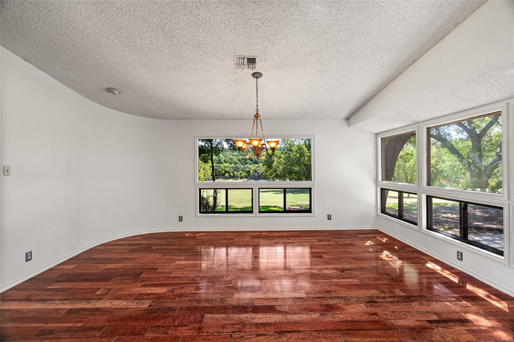 7508 Ravenswood Road Granbury, TX 76049 - Photo 20 of 40 a view of an empty room with wooden floor and a window