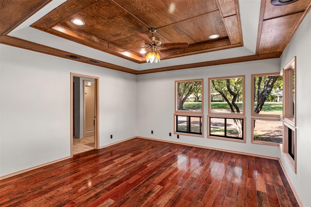 7508 Ravenswood Road Granbury, TX 76049 - Photo 21 of 40 a view of an empty room with wooden floor and a window