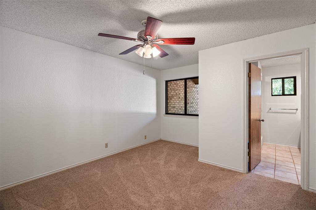 7508 Ravenswood Road Granbury, TX 76049 - Photo 26 of 40 an empty room with windows and fan