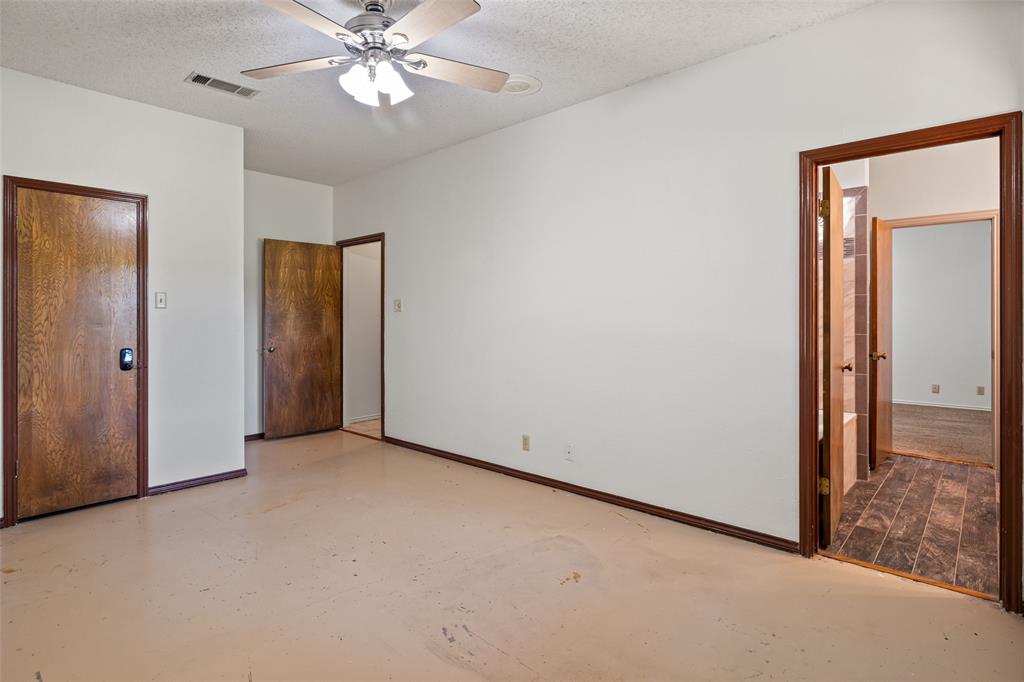 7508 Ravenswood Road Granbury, TX 76049 - Photo 31 of 40 an empty room with fan and entrance